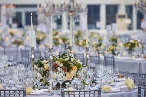 Luxurious table settings within a glass extension build for an Asian wedding at Blenheim Palace