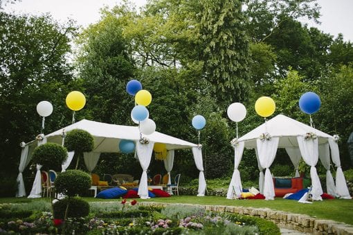 Bespoke kids birthday party with beautiful white raj structures, large colourful balloons in a private estate in Hampstead, London