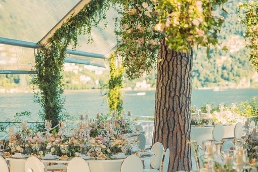 Lake Como, Italy wedding reception at Villa Pizzo with a bespoke Octagonal glass marquee, floral chandeliers and bespoke mirrored tables for Nigerian White Wedding