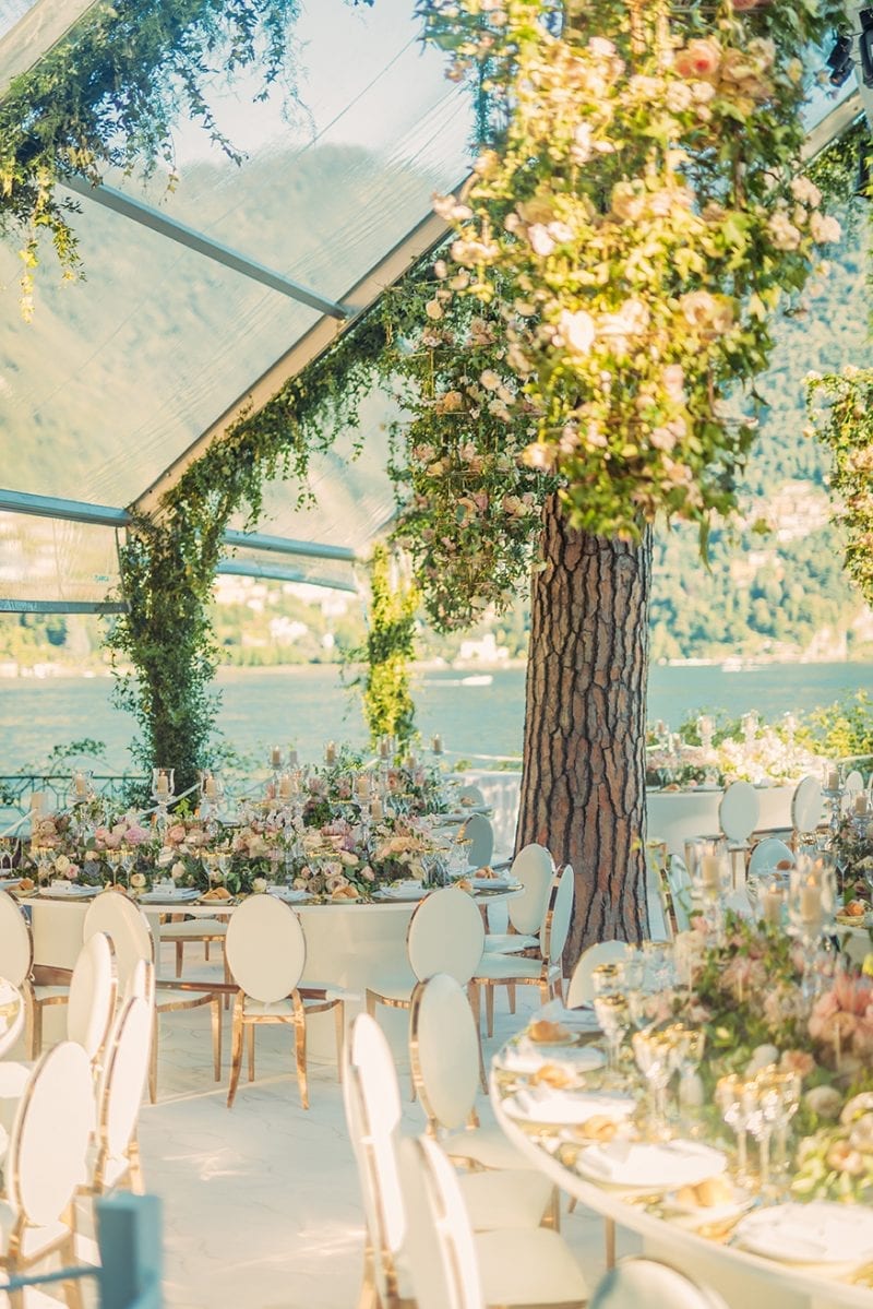 Lake Como, Italy wedding reception at Villa Pizzo with a bespoke Octagonal glass marquee, floral chandeliers and bespoke mirrored tables for Nigerian White Wedding