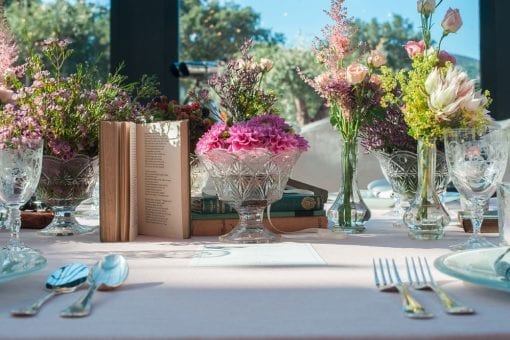 Vintage table styling using crystal vases, flowers and books at Le Beauvallon, St Tropez