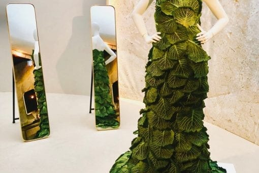 A fashion mannequin showcasing a dress made of cabbage leaves at an event for a Gaggenau product launch in London UK