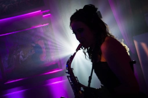 Silhouette of a woman playing the saxophone at a luxury birthday party