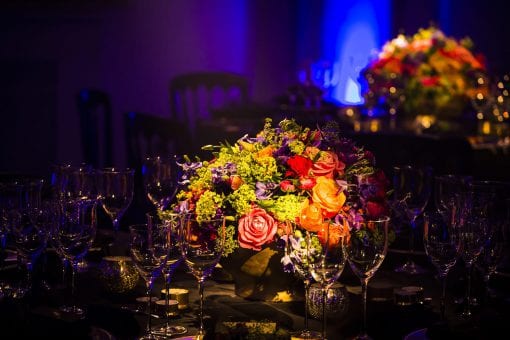 Colourful floral centrepiece in the middle of a table set for dinner at One Marylebone