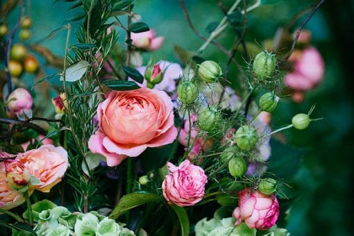 Pink flowers, thistles and leaves in stunning wedding flower arrangement