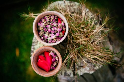 Detail shot of real rose petals and rose buds at a rustic elegant wedding