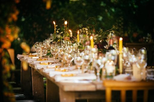 Candlelit table set for dinner at a luxury wedding in the English countryside