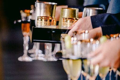 Drinks reception with champagne in gold etched glasses at Hampton Court Palace