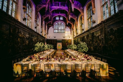 Impactful tablescape with purple and cream colour palette in the Great Hall at Hampton Court Palace