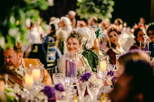 Guests in period costume during dinner at a lavish birthday party at Hampton Court Palace