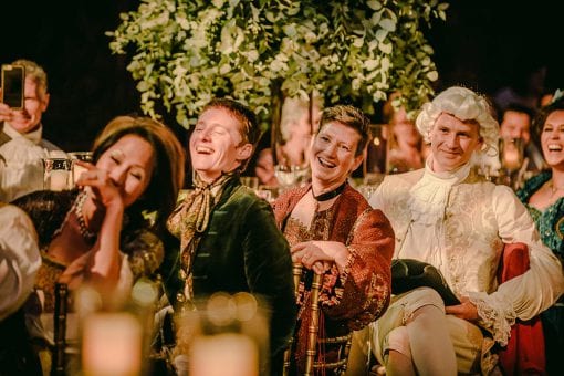 Guests laughing at fabulous entertainment at a lavish event held at Hampton Court Palace