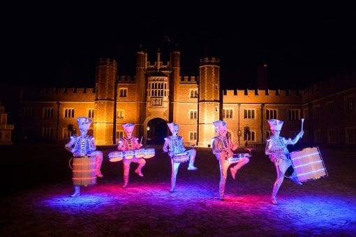 The LED drummers performing with drums outside Hampton Court Palace at night