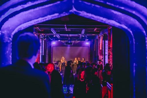 Guests dancing in a purple lit dance floor at Hampton Court Palace