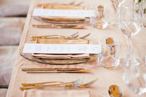 Long table set for dinner with a floral table runner