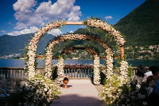Stunning floral wedding arches overlooking Lake Como at exclusive wedding venue Villa Pizzo for a luxury wedding ceremony in Italy