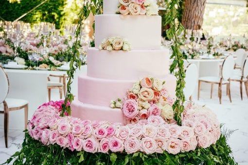 High end six tier white and pink ombre wedding cake beautifully decorated with pink and white flowers for a luxury destination wedding in Lake Como