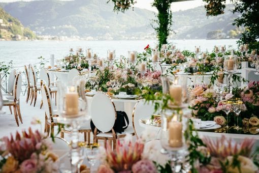 Elegant wedding reception styled with fresh flowers and candles overlooking Lake Como, Italy