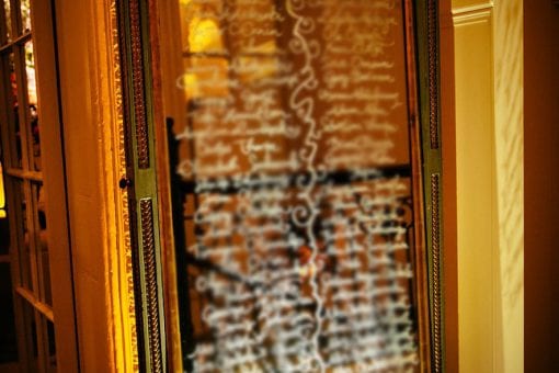 Calligraphy on mirror for a seating plan at a luxury party in Mandarin Oriental Hotel in London