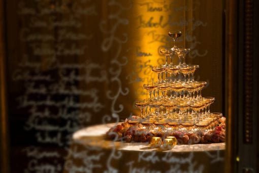 A champagne tower on a bed of roses at a drinks reception at the Mandarin Oriental, London