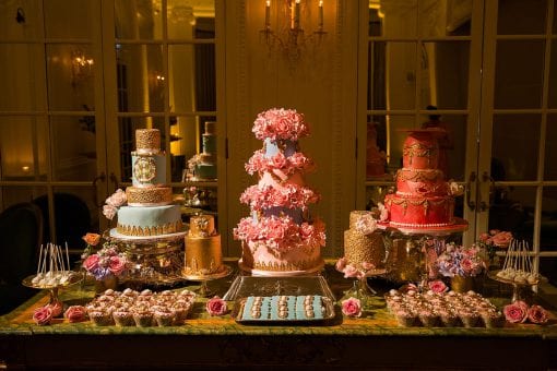 A stunning dessert and cake station with luxury cakes, cupcakes, cake pops with gold leaf and stunning detailing