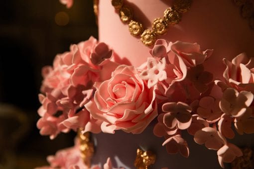 Luxury birthday tiered cake with pink and gold detailing including handmade flower icing.