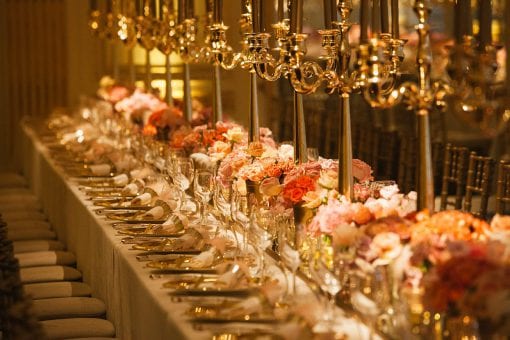 Beautiful floral tablescape with hundreds of pink and peach roses creating a gold opulent style at the Mandarin Oriental