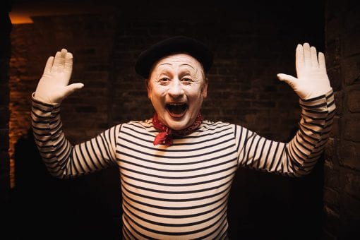 A mime artist performing at a Moulin Rouge themed event in Mayfair