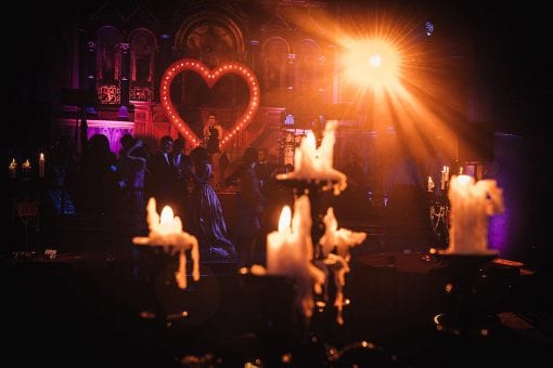 Wax candles on black candelabras at a Moulin Rouge Party in Mayfair