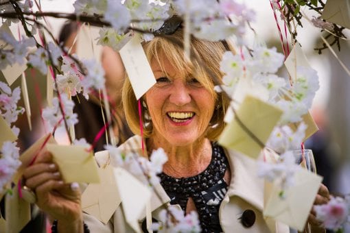 Escort cards hanging from a cherry tree at luxury wedding in London