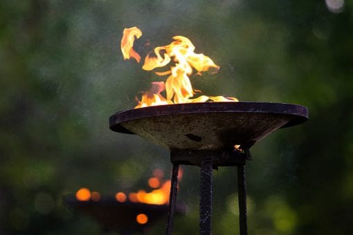 An array of tall flambeaux in Regents Park for a luxury wedding reception